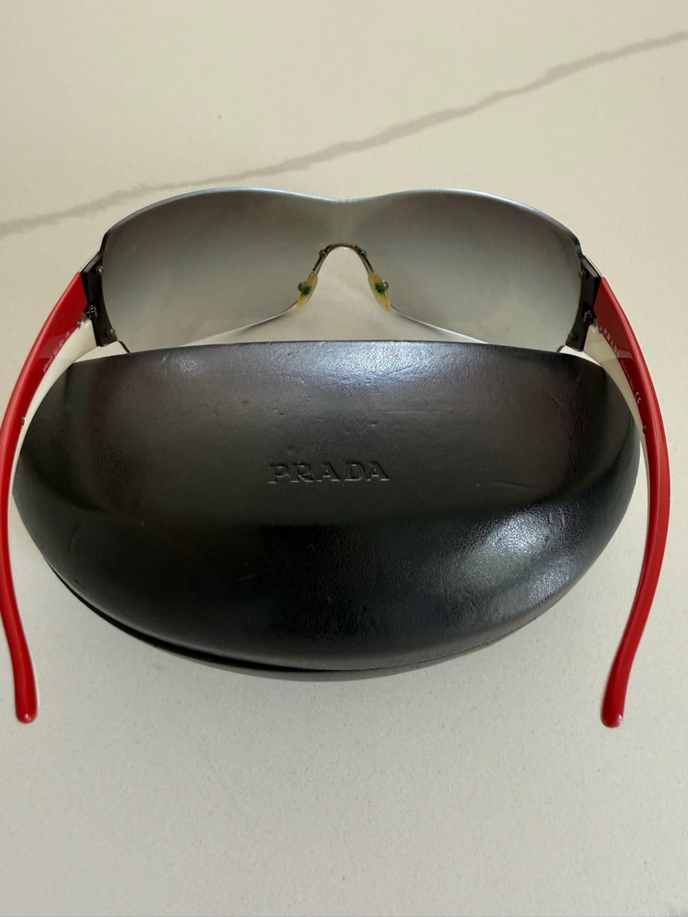 Prada Rimless Shield Sunglasses in Clear Gradient with Red/White stripe - Picture 2 of 11